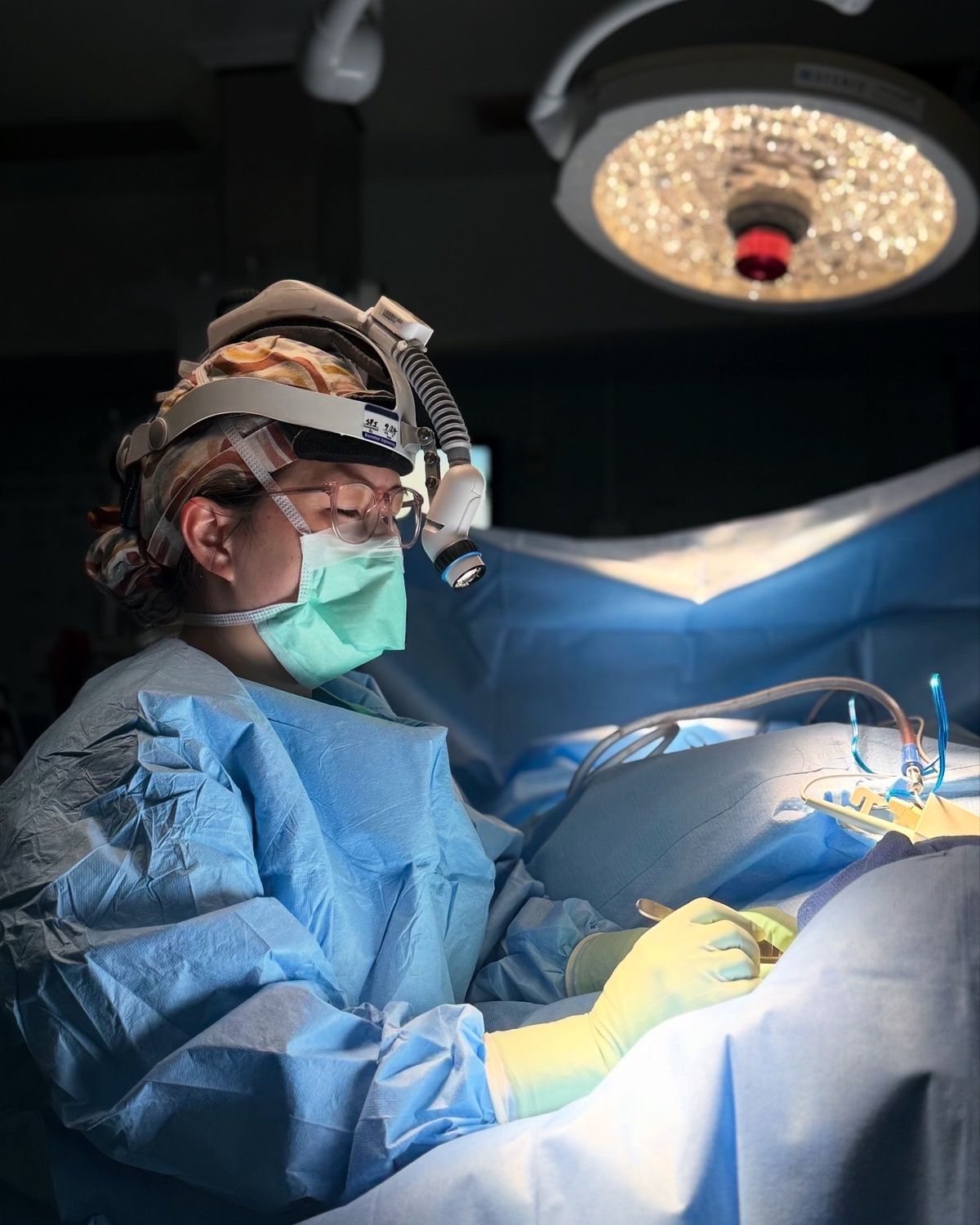 Surgeon performing surgery in an operating room.