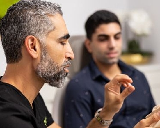 Dr. Nima Shemirani and Dr. Keon Parsa reviewing plastic surgery patients on a tablet