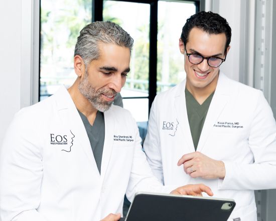 Dr. Nima Shemirani and Dr. Keon Parsa reviewing plastic surgery patients on a tablet