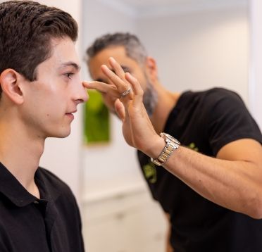 Dr. Nima Shemirani, Beverly Hills plastic surgeon with patient