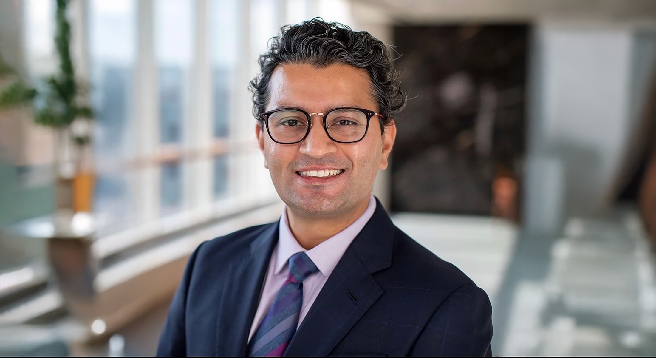 Professional man smiling in a modern office.