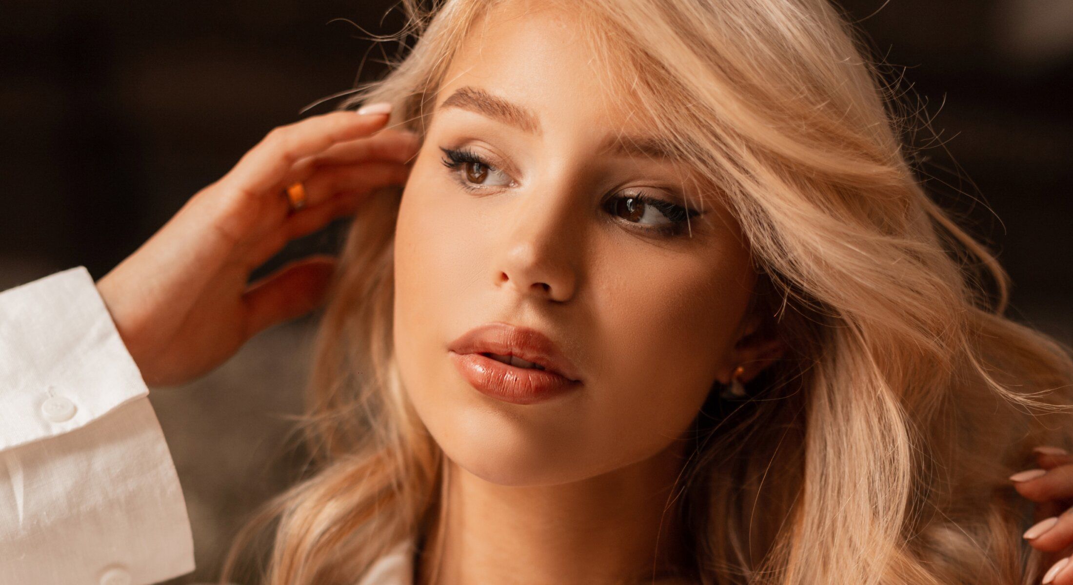 Close-up of woman with blonde hair and makeup.