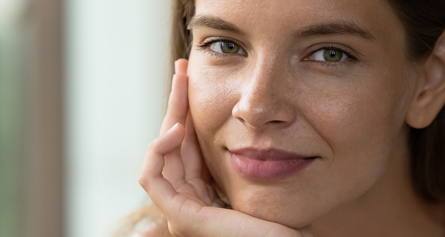 Woman with thoughtful expression and soft smile.