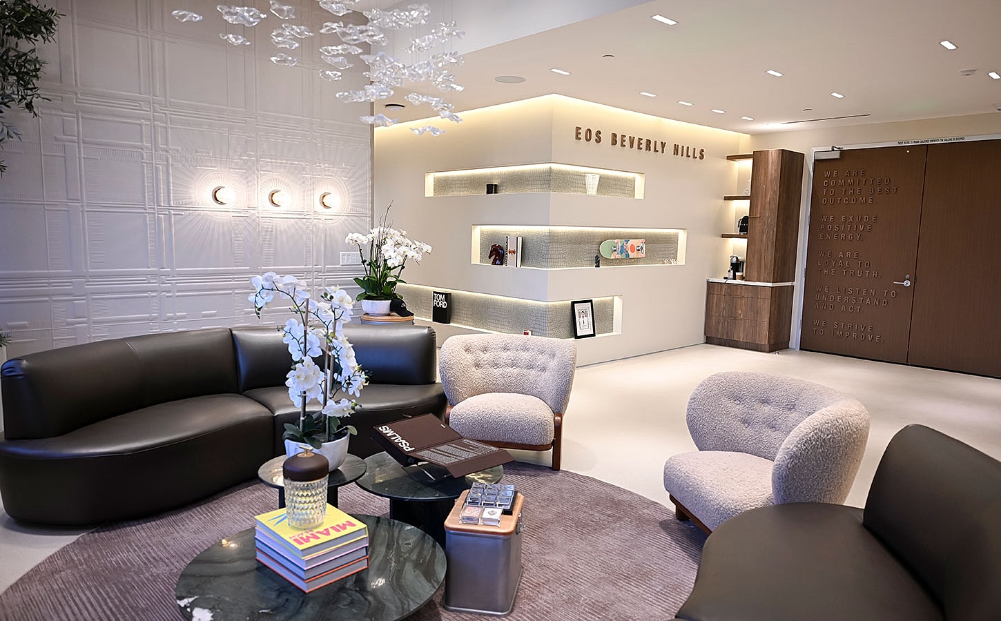 Modern lounge with plants and stylish seating.