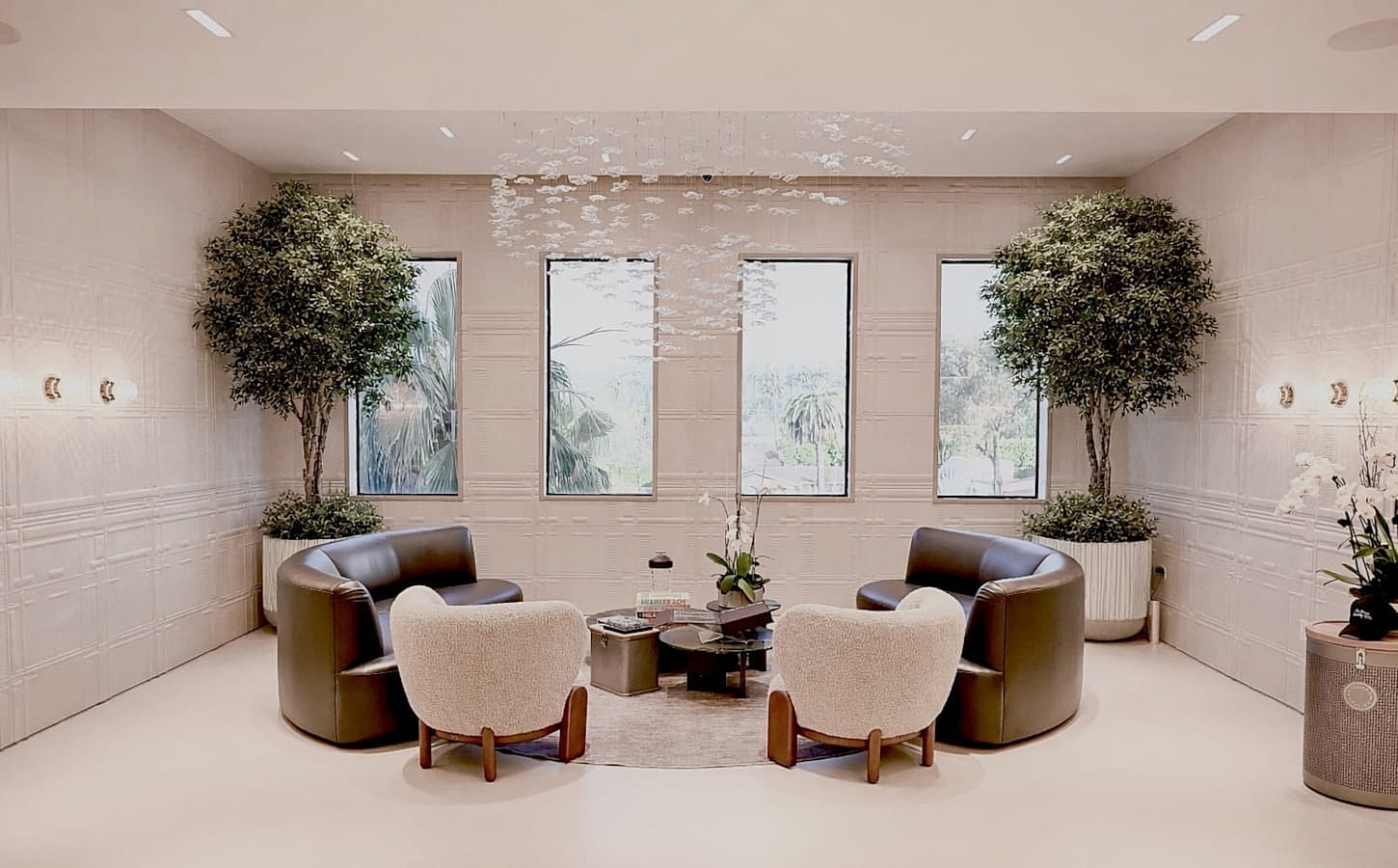 Modern lounge with plants and stylish seating.