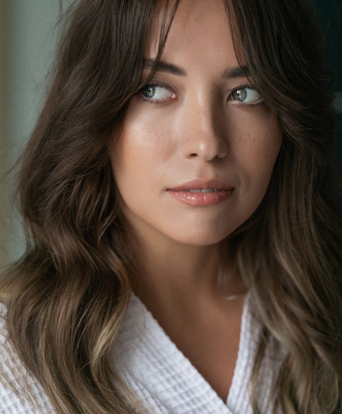 Close-up of a woman in a white robe.