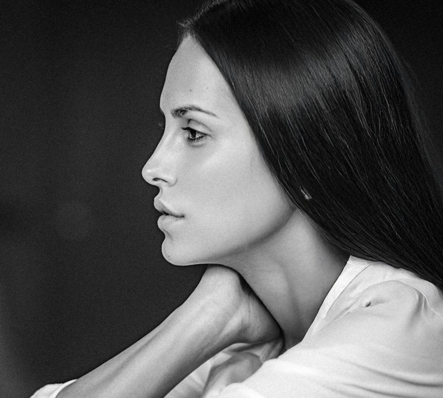 Profile of a woman with long, dark hair.