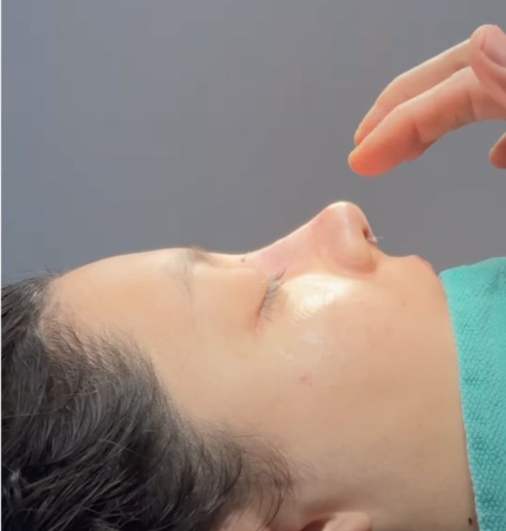 Person relaxing with hand near face.