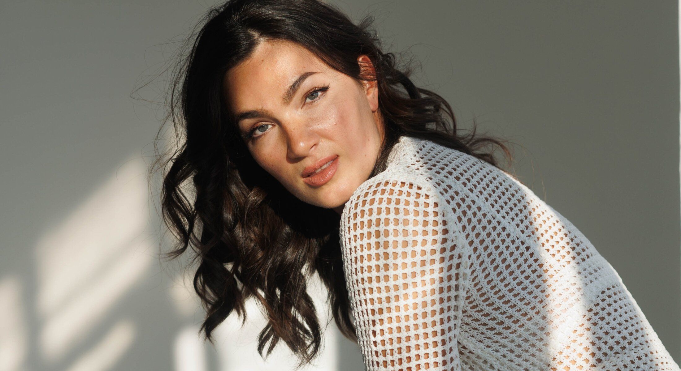 Portrait of a woman with curly hair.